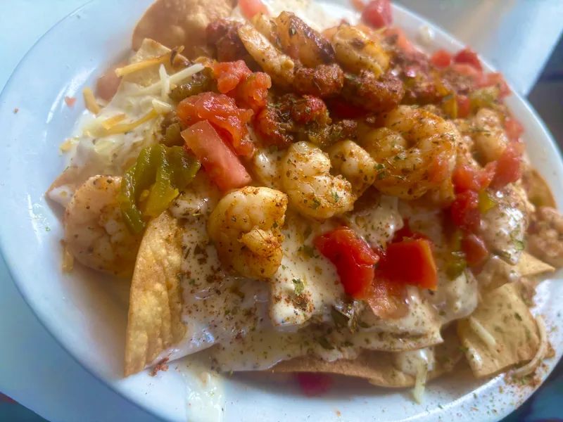 Seafood Nachos at Chef Charles Bistreaux: fried chips piled with seasoned Louisiana shrimp, creamy cheese sauce, diced tomato, and peppers