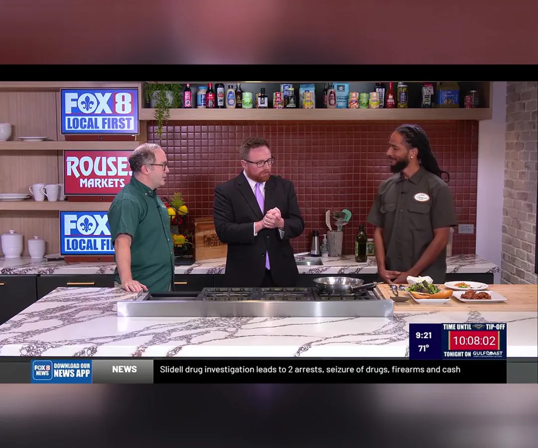 Kevin Pedeaux, FOX 8 host Rob Krieger, and Jajuane Harris from FRSH Juice and Food Company at St. Roch Market cooking live on the FOX 8 Morning Show in New Orleans